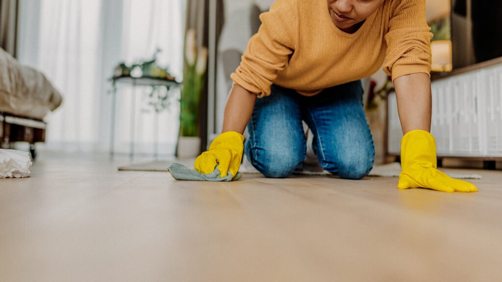 Woman cleaning a wooden floor