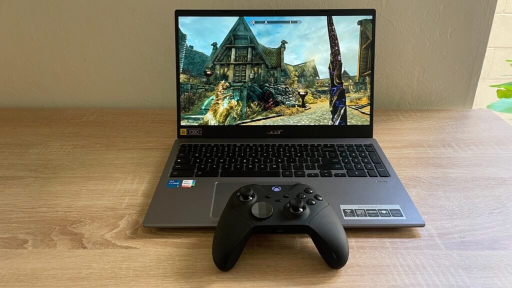 The Steam beta running on a Chromebook. The laptop is atop a wooden desk with a black Xbox controller sat on the front edge.