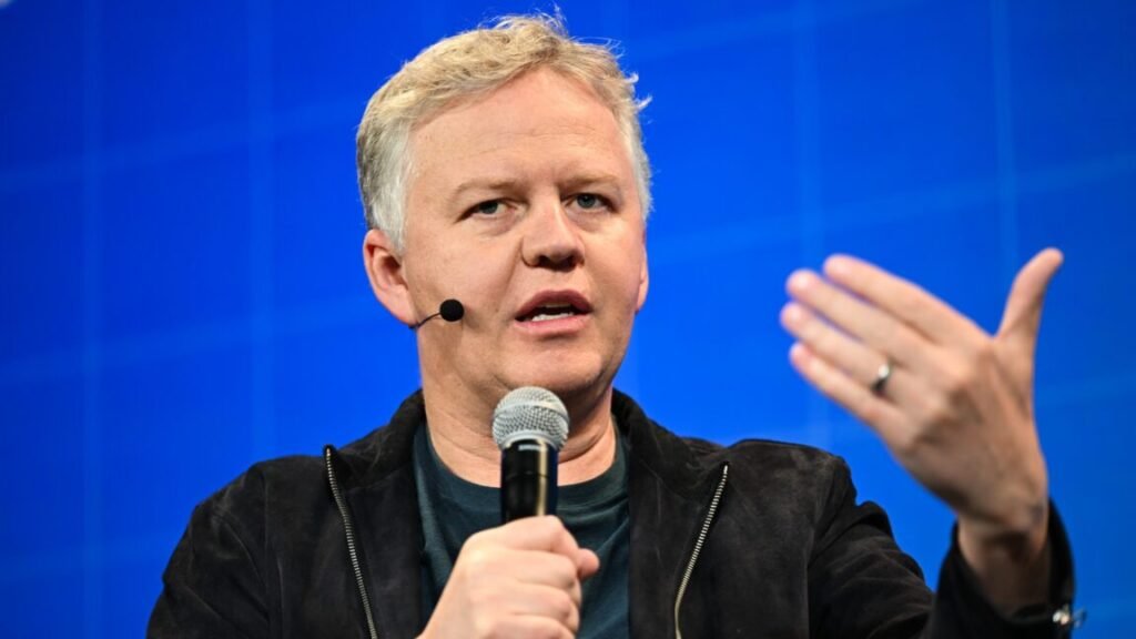 Cloudflare CEO Matthew Prince holding a microphone and speaking at a conference.