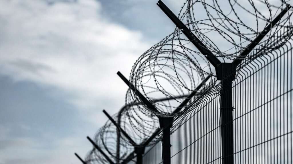 A barbed wire fence such as those used at prisons.