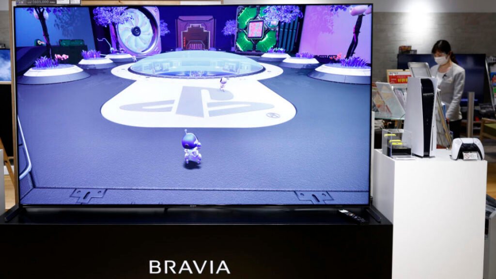 A Sony Group Corp. PlayStation 5 (PS5) video game console and a controller displayed next to a Bravia XR 4K television at the company's showroom inside the Ginza Place building in Tokyo, Japan, on Wednesday, Oct. 27, 2021.