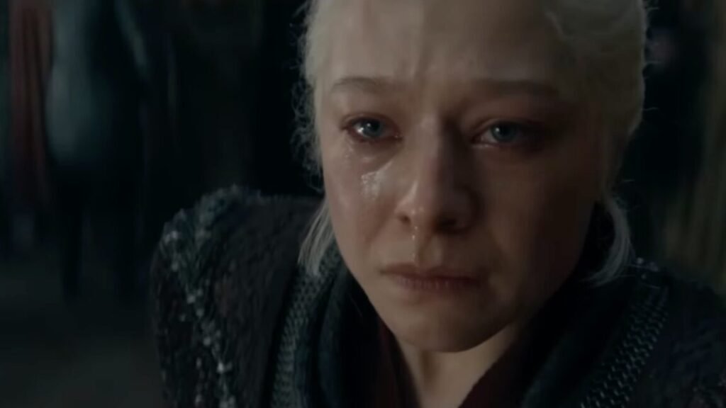 woman with white-blonde in Targaryen black garb, raising her tear stained face upward.