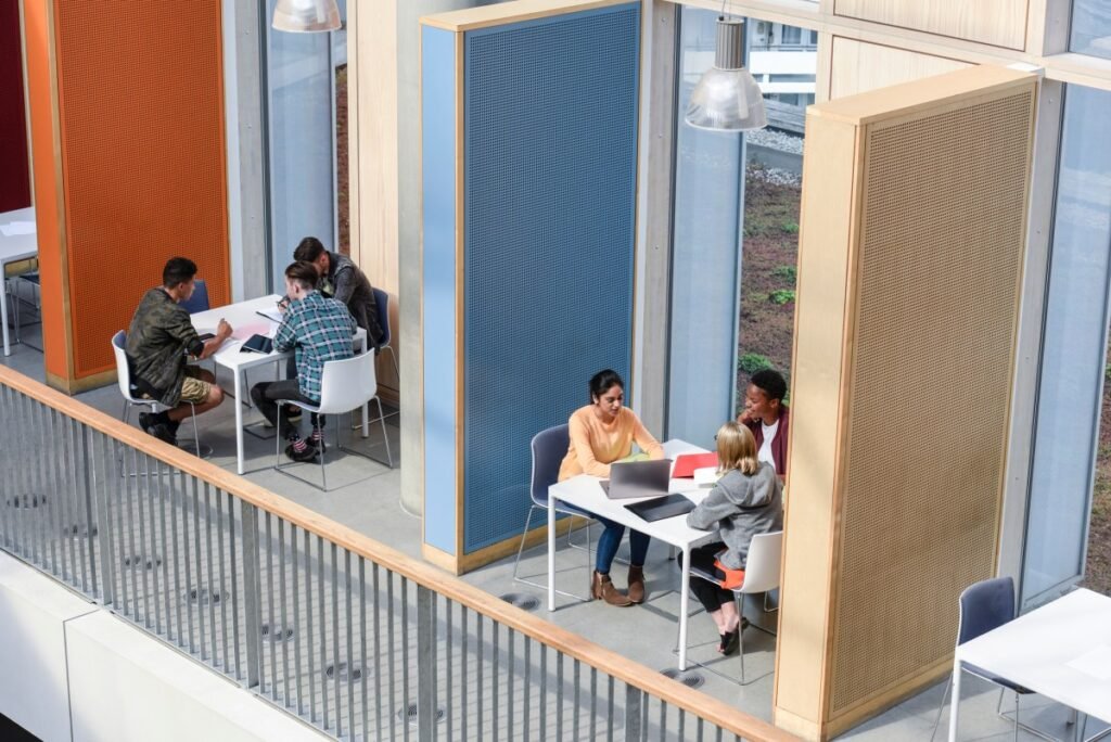 Groups of college students sitting in booths, discussing