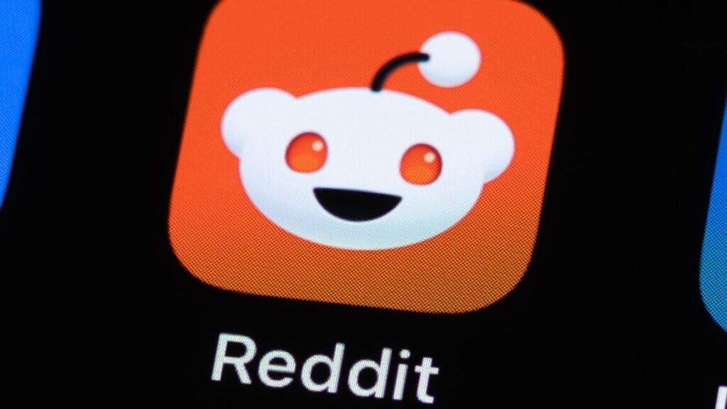 UK fines Reddit for not checking user ages aggressively enough A Reddit app icon on a phone screen.