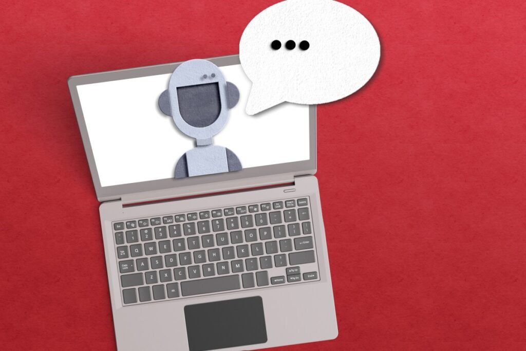 Meta is having trouble with rogue AI agents AI agent concept with robot inside a laptop with a voice bubble on red background.