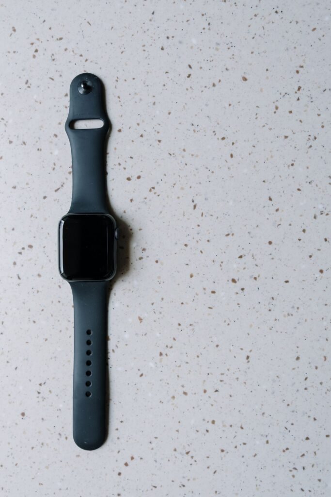 Black smartwatch on a terrazzo surface representing wearable health trackers