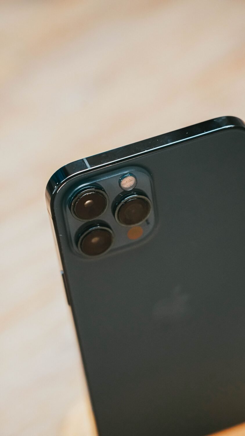 Close-up of an iPhone Pro triple camera module with 48MP main, ultra wide and telephoto lenses