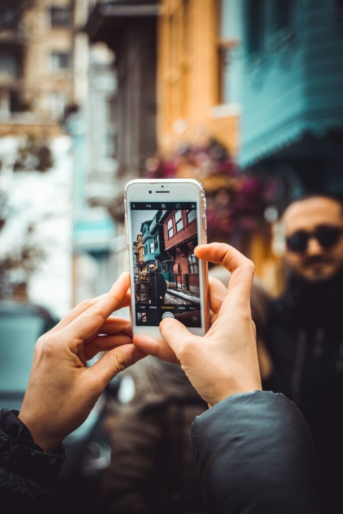 Oppo Find X9 Ultra: The Camera Phone That Has Reviewers Rethinking the Rankings Close-up of hands holding a smartphone with a multi-lens camera system, taking a photo