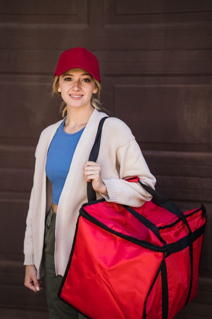 Food delivery courier holding an insulated delivery bag