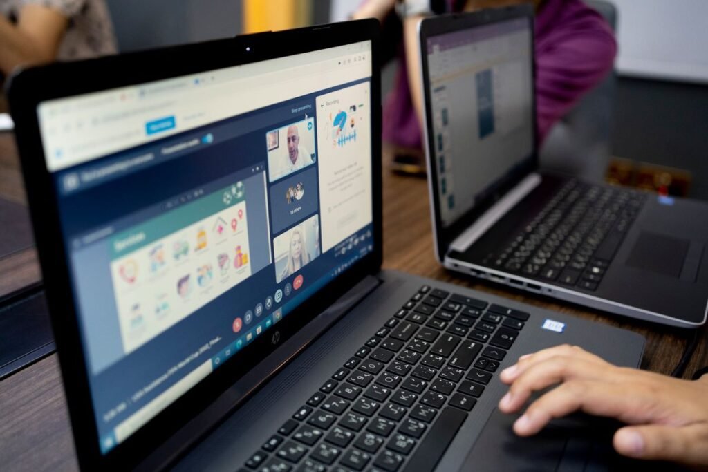Person making a video call on a laptop during an online meeting