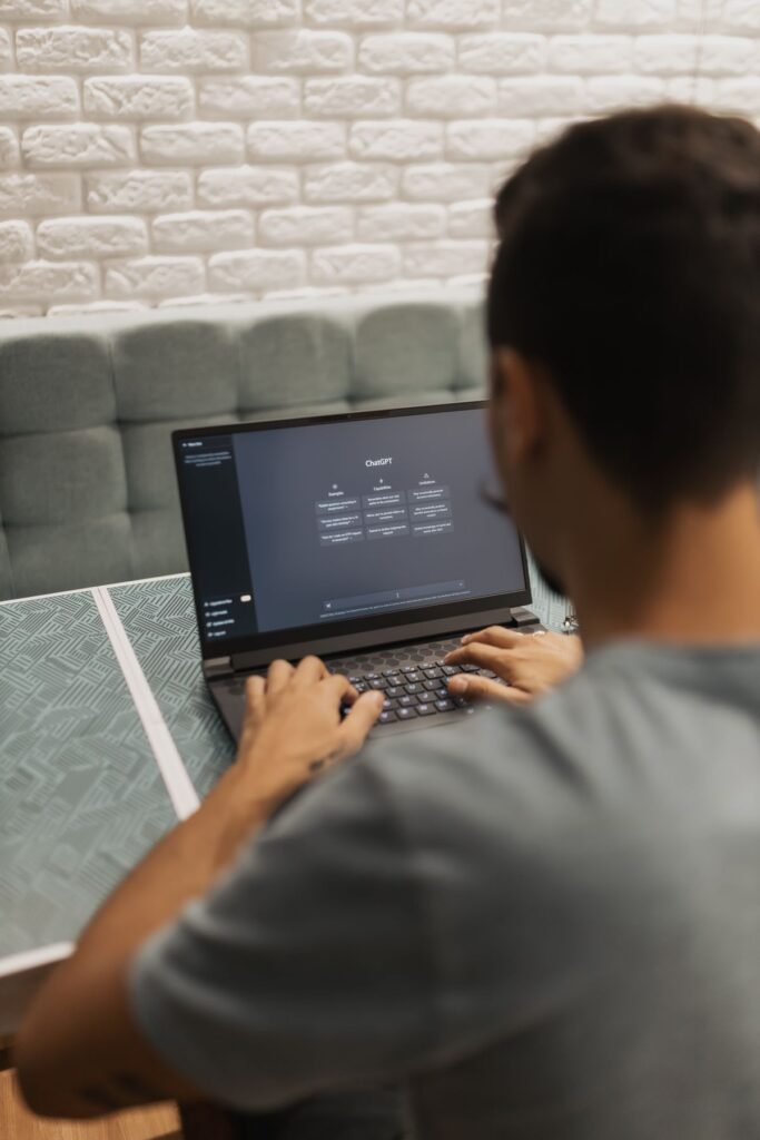 How to Use ChatGPT: A Beginner’s Guide Person using the ChatGPT AI chatbot on a laptop