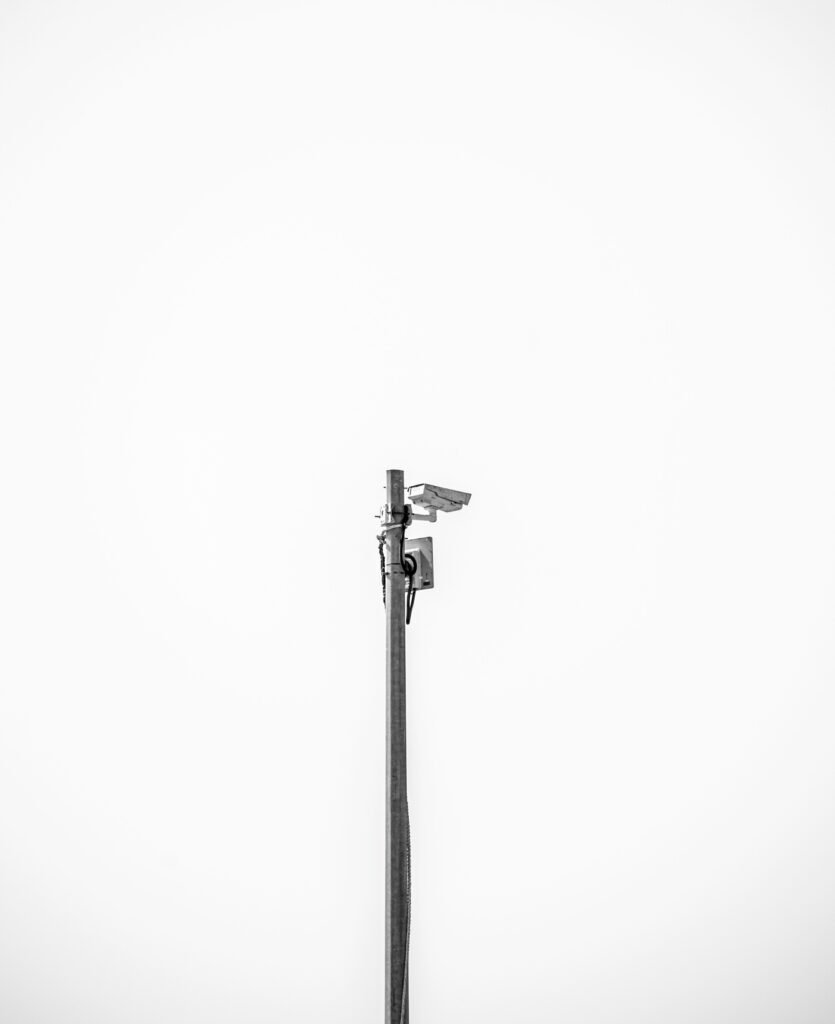 Automated license plate reader camera mounted on a pole, used for vehicle and device tracking