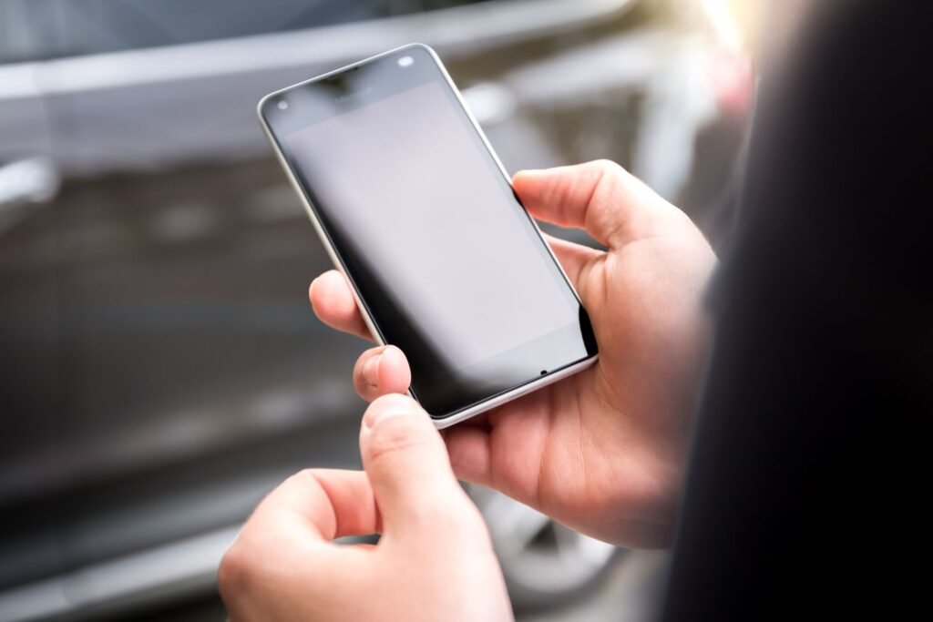 Hand holding a smartphone with a dark screen, symbolizing Samsung's next foldable phone reveal