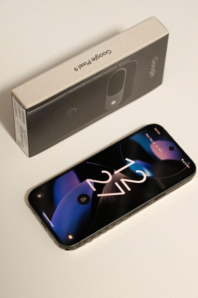 Google Pixel 10 Battery: mAh & Real-Life Endurance Close-up of a Google Pixel smartphone held in one hand next to its retail box