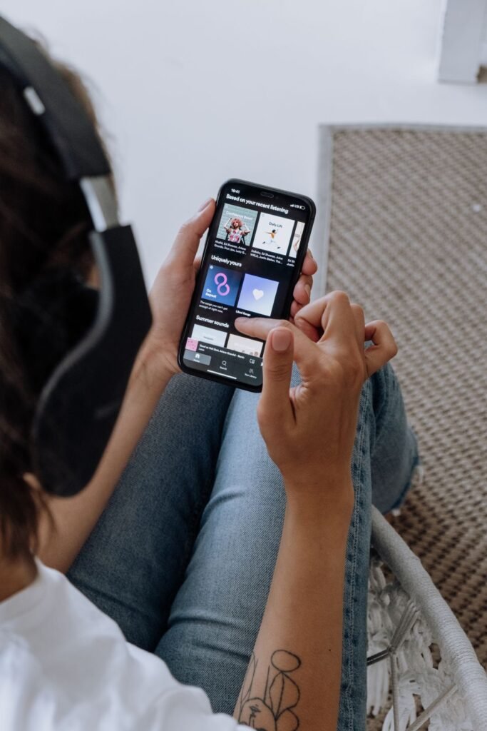 Person listening to music on a smartphone using a free music app