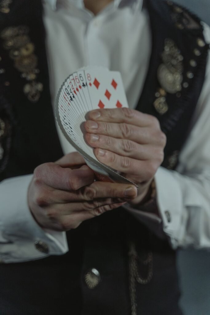 Person holding a fan of playing cards