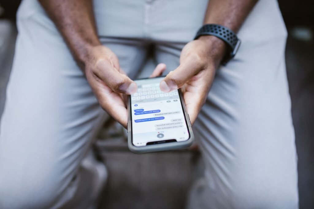 How to Use Instant Messaging and Direct Messages Close-up of a person's thumbs typing a text message on a smartphone