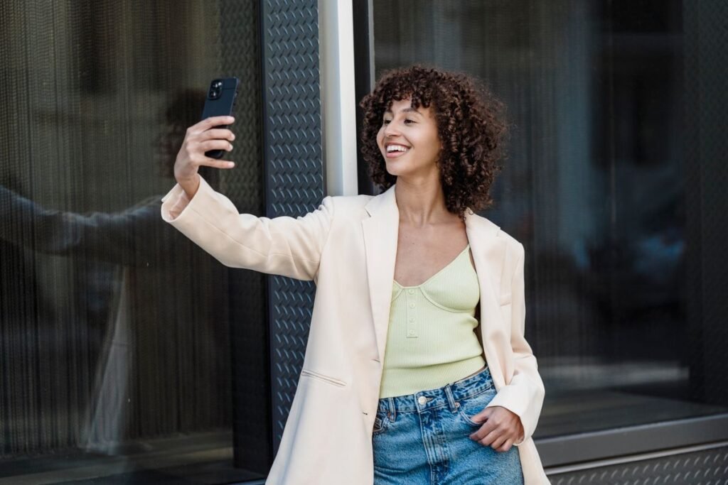 How to Use Snapchat Filters and Lenses Woman taking a selfie self-portrait on her smartphone