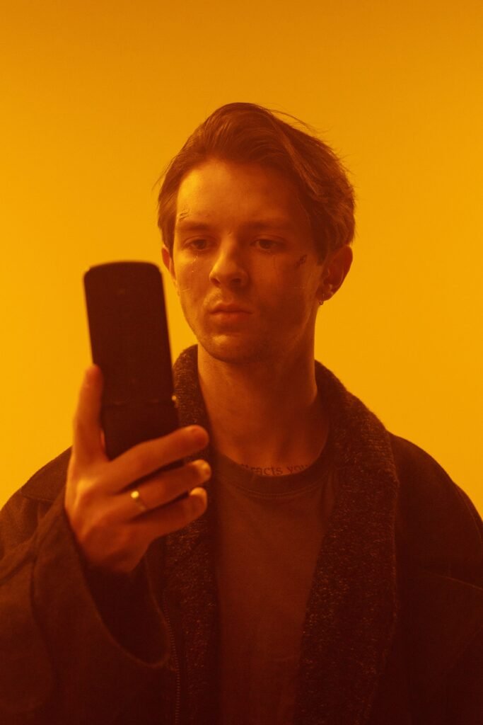 Man holding a retro-style flip phone, representing the minimalist Light Flip phone