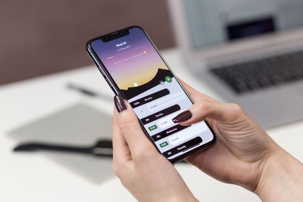 A person holding a smartphone displaying its screen