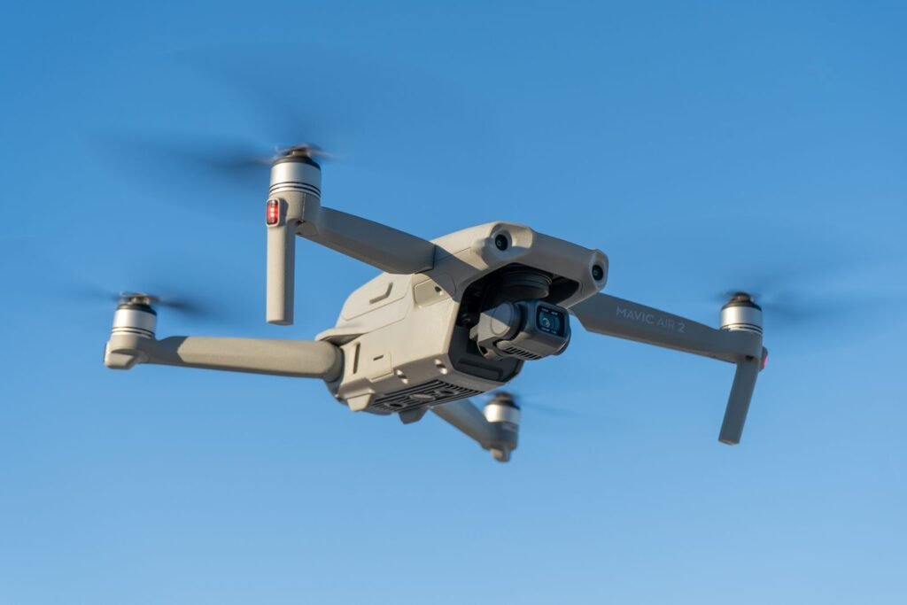 Amazon Wants a Drone Over 500 US Towns This Year. Your Package Has to Weigh Under Five Pounds. A delivery drone in flight against an open sky, illustrating Amazon Prime Air's expansion to nearly 500 US cities