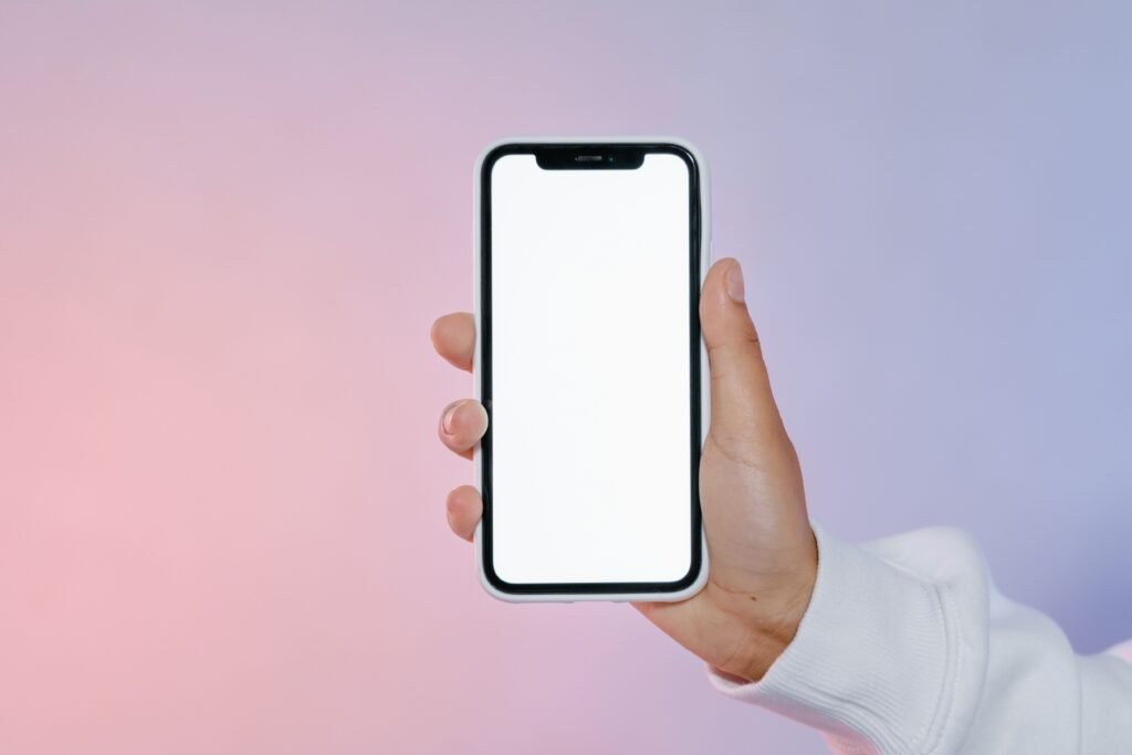 Hand holding an Android smartphone, representing the Android 17 update rollout across phone brands in 2026