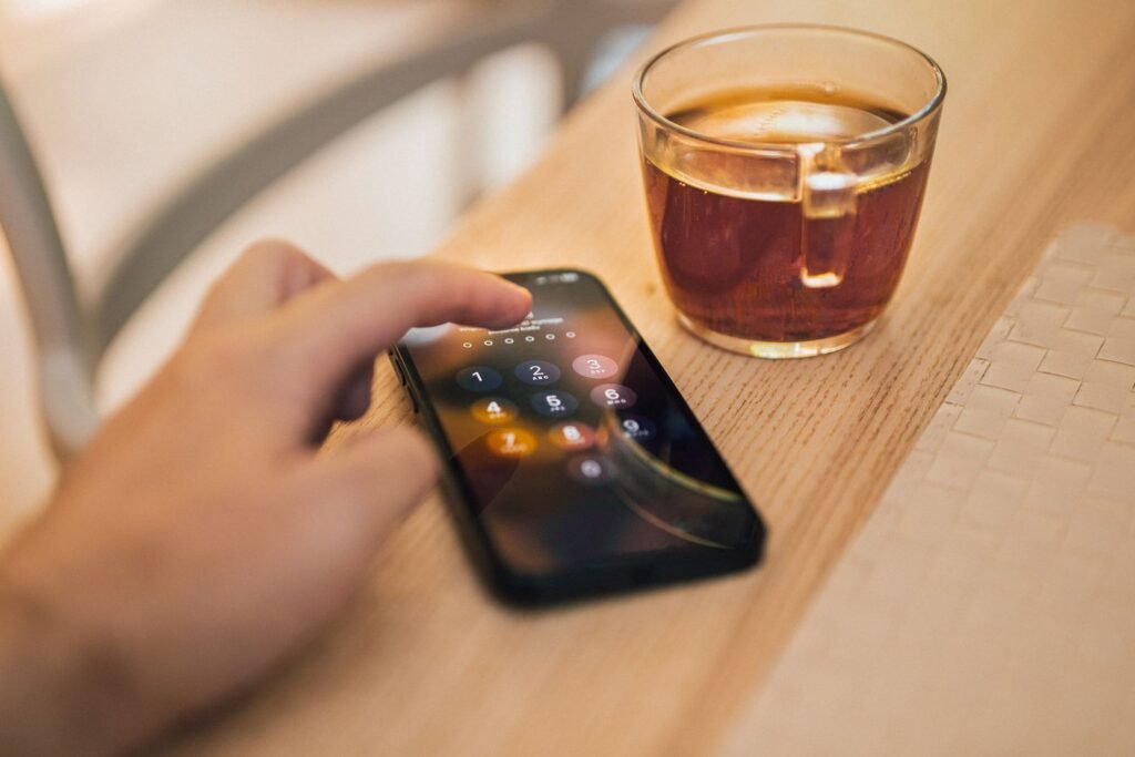 Close-up of a person unlocking a smartphone screen with one hand