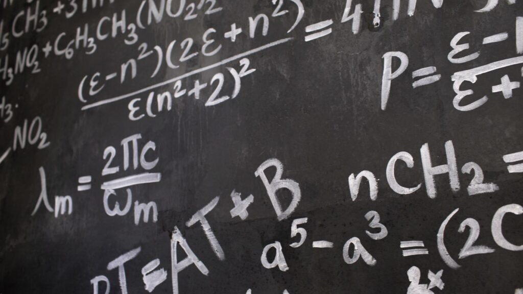 A Brain Surgeon Left ChatGPT Running for 16 Hours. It Closed a Problem Mathematicians Had Circled Since 2004. Close-up of complicated mathematical equations written in chalk on a blackboard, illustrating the proof of Crouzeix's conjecture