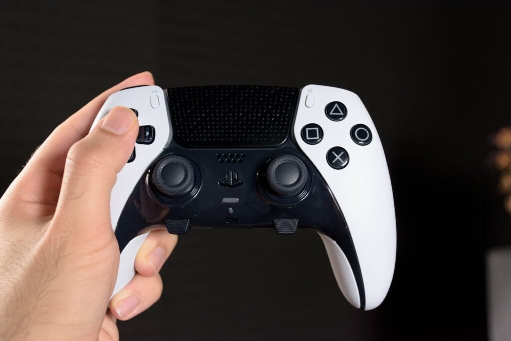 A hand holding a modern game controller against a dark background, illustrating the GTA 6 leak story