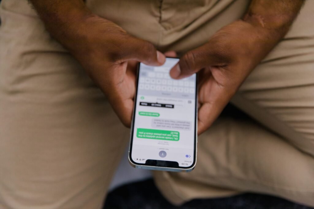 Close-up view of a man texting on a smartphone
