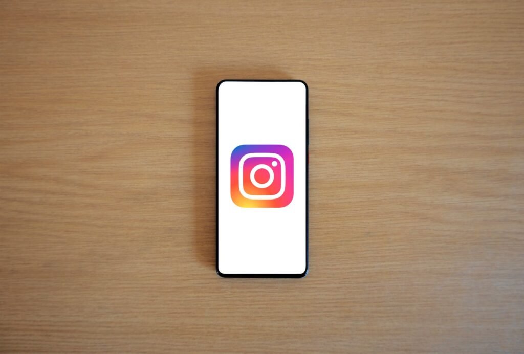 Smartphone displaying the Instagram logo on a wooden surface