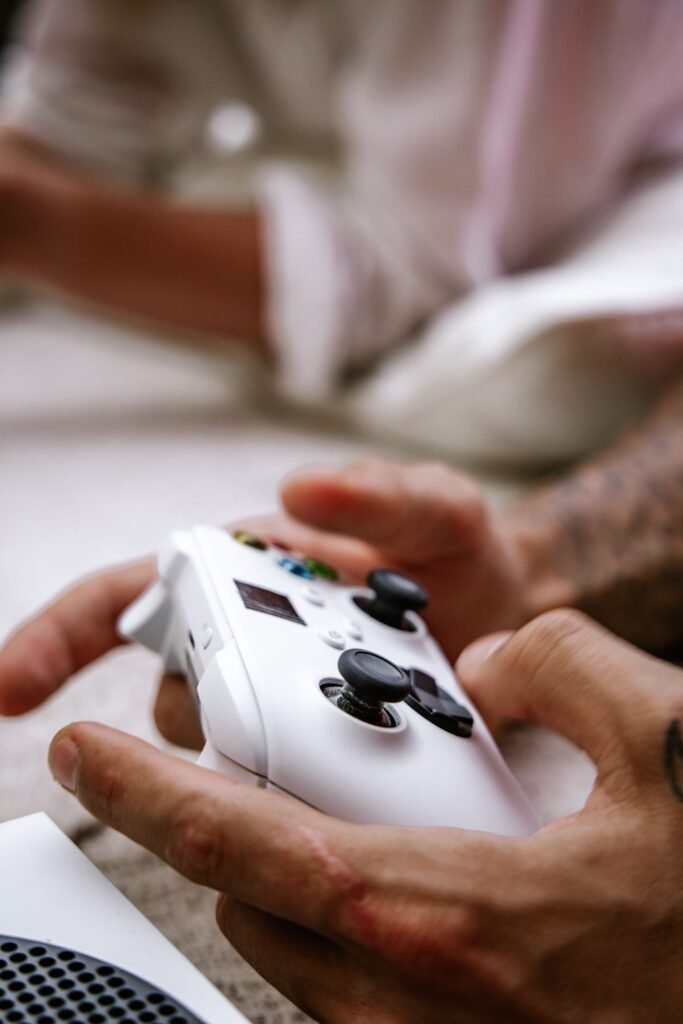 Person holding a video game controller while playing