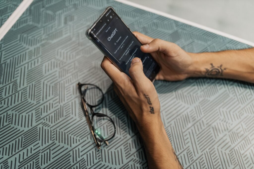 Person holding a smartphone showing an AI chat assistant app