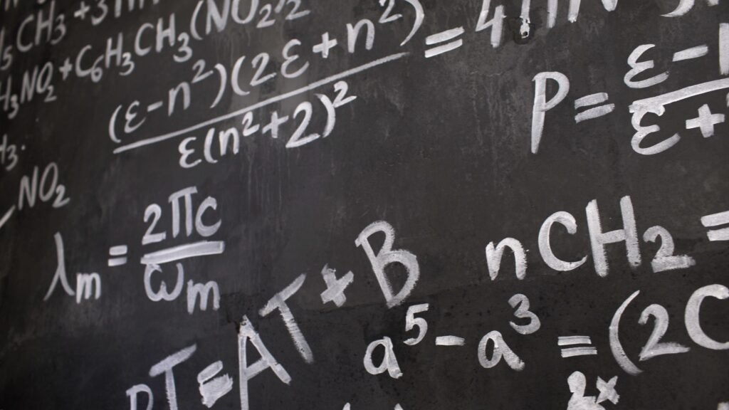 Blackboard covered in handwritten mathematical equations