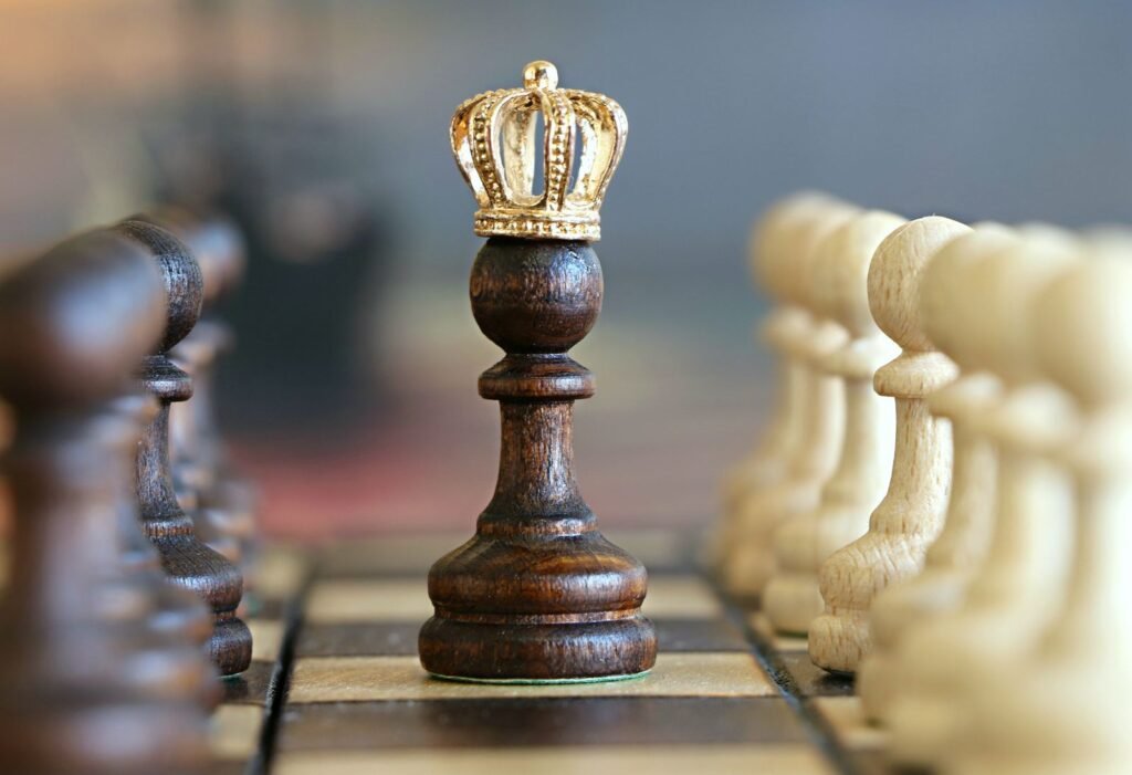 A crowned pawn chess piece standing between opposing ranks of pawns, symbolizing Amazon's Mechanical Turk and its "artificial artificial intelligence" concept