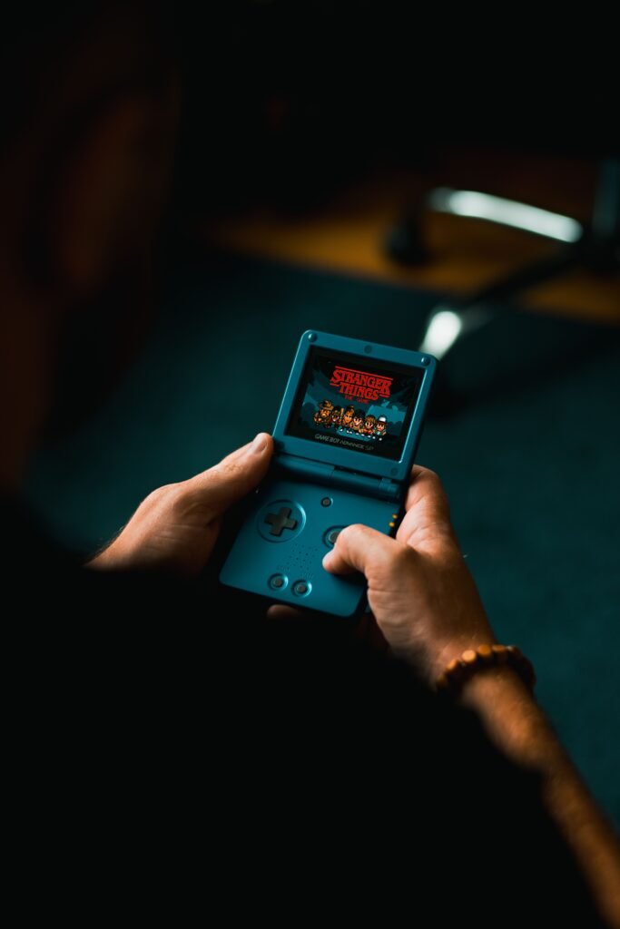 Close-up of a person holding a retro handheld game console, illustrating the rare Phosphatine Game and Watch units heading to auction