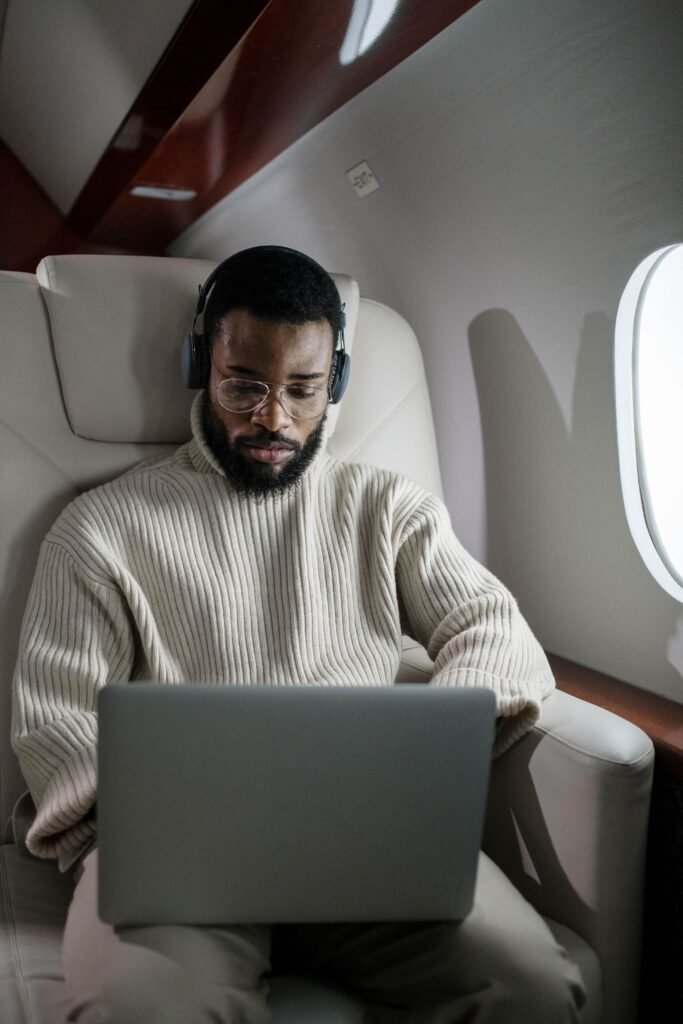 A Laptop Caught Fire Mid Cabin on American Airlines 2398, and the FAA Wants to Know Why A passenger working on a laptop inside an airplane cabin, illustrating the lithium battery fire on American Airlines Flight 2398