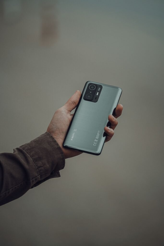 A hand holding a modern Android smartphone, representing Google's four phone Pixel 11 lineup for 2026
