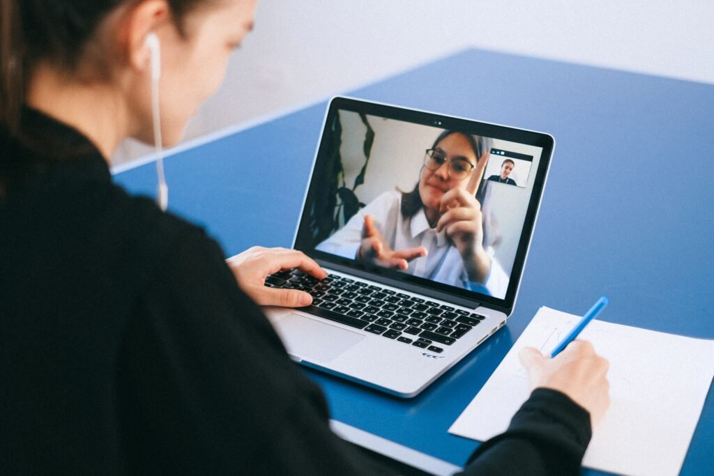 A laptop screen showing participants in a video conference call, illustrating the Zoom Zoomsday zero-click vulnerability