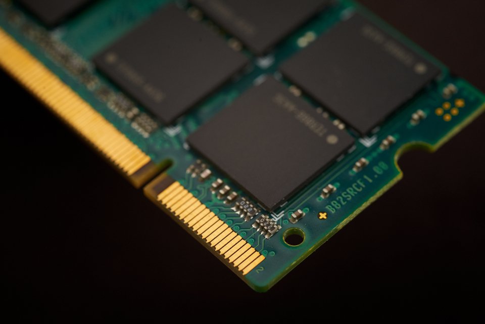 AMD Is Paying $8.2 Billion for Fei-Fei Li’s World Labs. Nvidia Is the Real Audience. Close-up macro photo of a computer chip and memory modules on a green circuit board