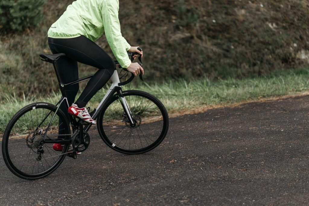 Best Smartwatch for Cycling in 2026: GPS Battery Life and Power Meter Support Compared Cyclist wearing a GPS smartwatch while riding a road bike outdoors