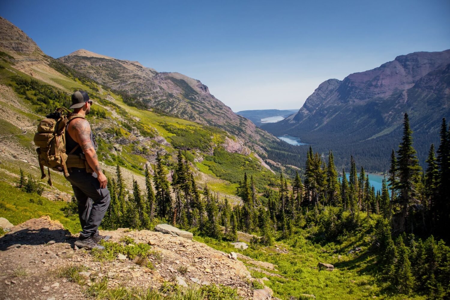 Hiker walking up a rocky mountain trail wearing a GPS smartwatch