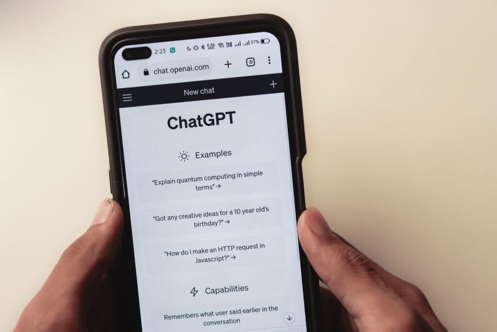 Hands holding a smartphone displaying an AI chatbot interface, illustrating how private chatbot conversations can be read by employers and courts