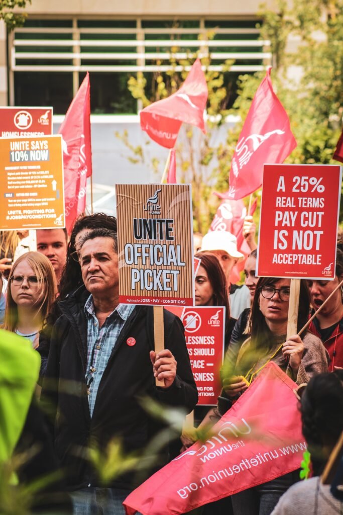 A crowd of demonstrators holding banners during a street protest
