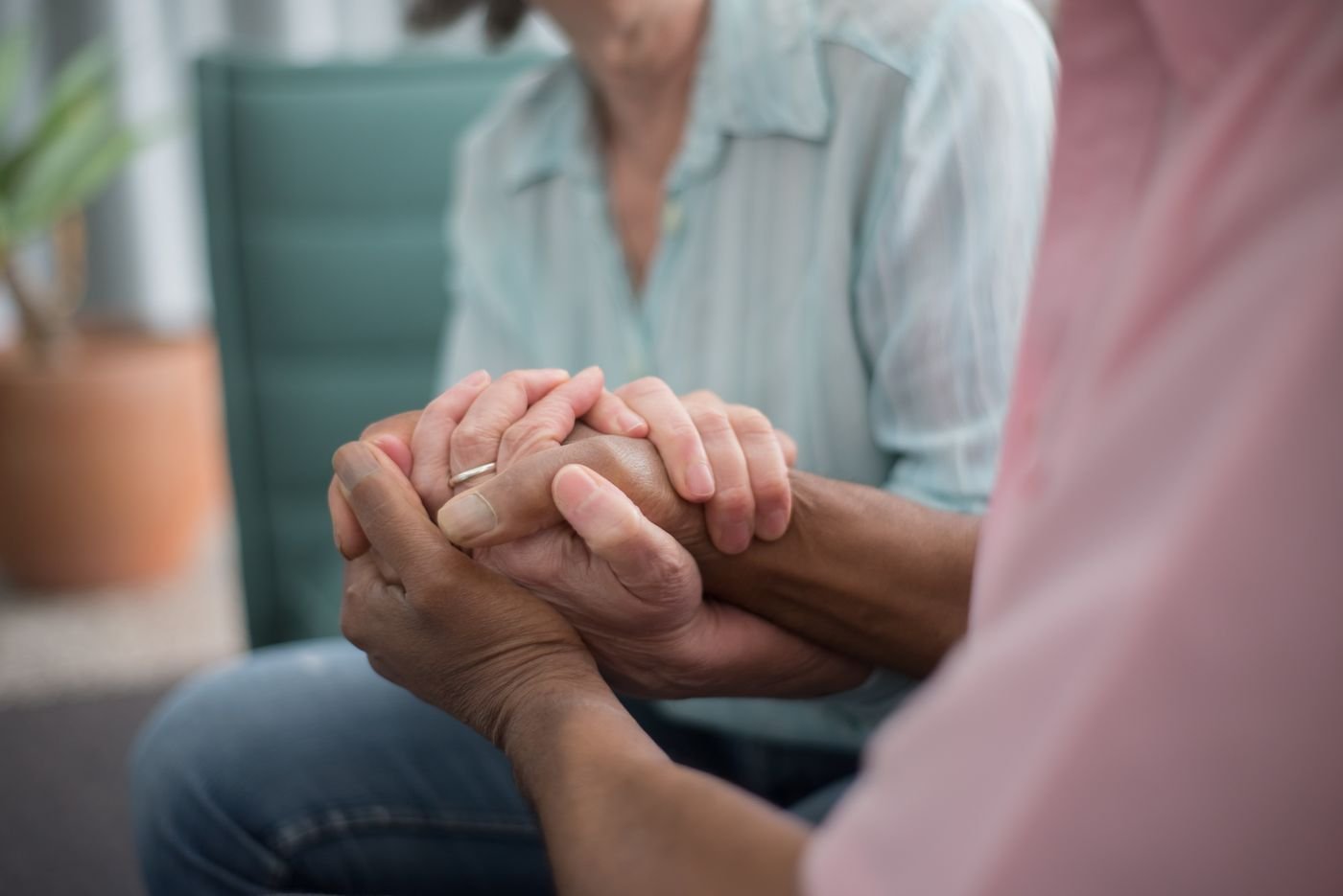 Elderly couple holding hands, representing a caregiver supporting a partner with dementia