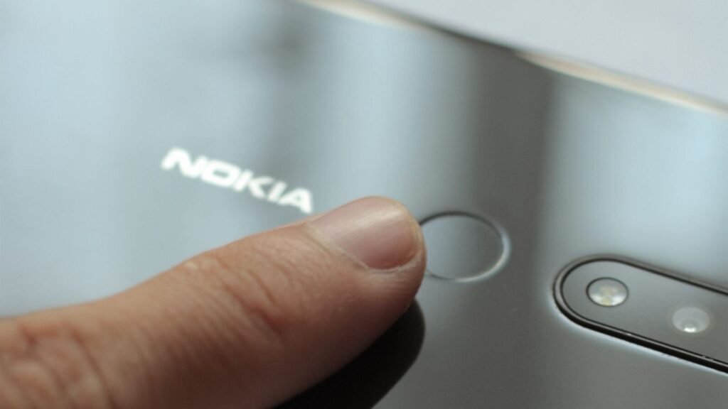 Close up of a finger touching the fingerprint scanner on a smartphone