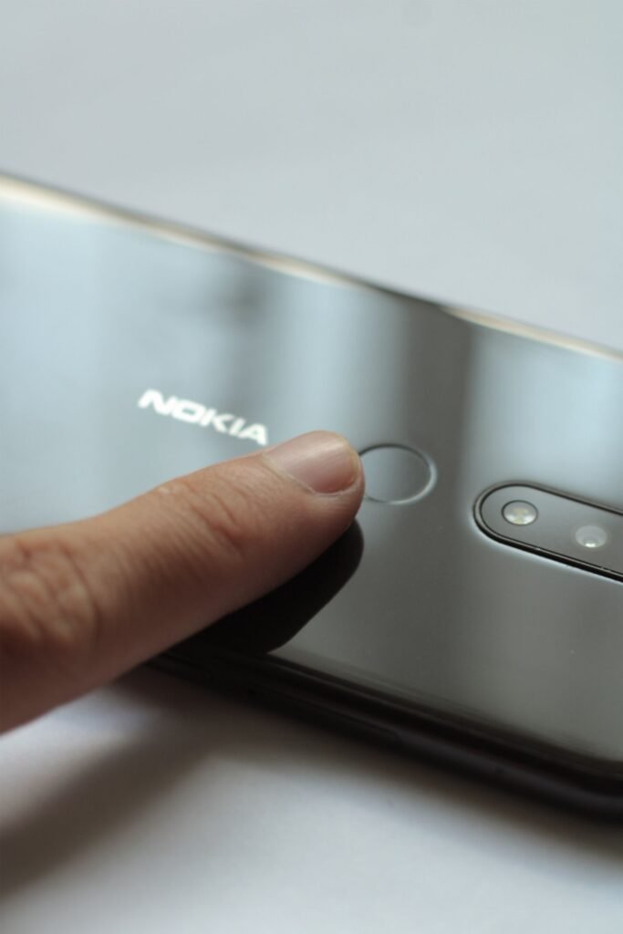 Passkeys vs Passwords: What Actually Happens When You Lose the Phone Close up of a finger touching the fingerprint scanner on a smartphone