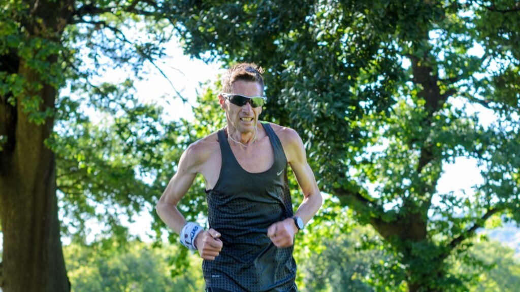 Garmin’s Q3 2026 Update Adds Fall Detection and Voice Control, and Coverage Isn’t Even Trail runner outdoors wearing a GPS sports watch, the kind of device receiving Garmin's Q3 2026 update