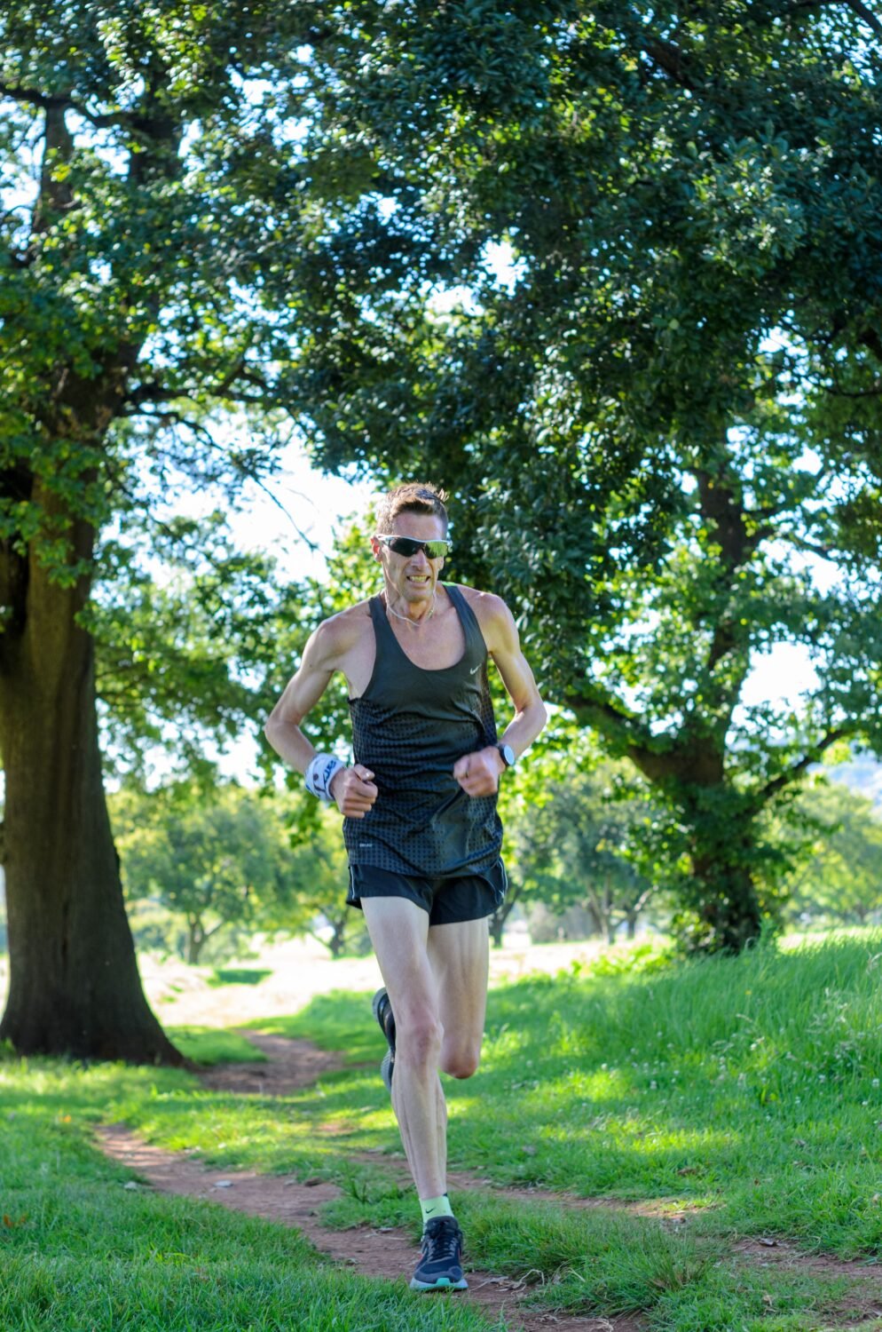 Trail runner outdoors wearing a GPS sports watch, the kind of device receiving Garmin's Q3 2026 update