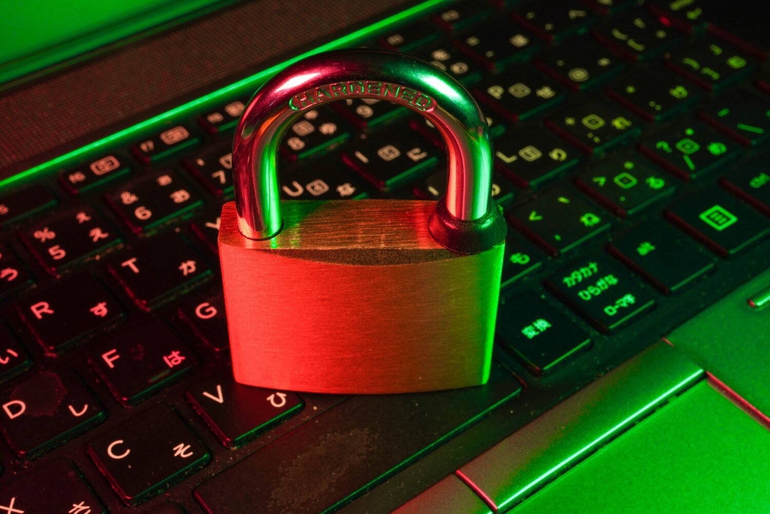 Red padlock resting on a black computer keyboard, symbolizing an AI security breach